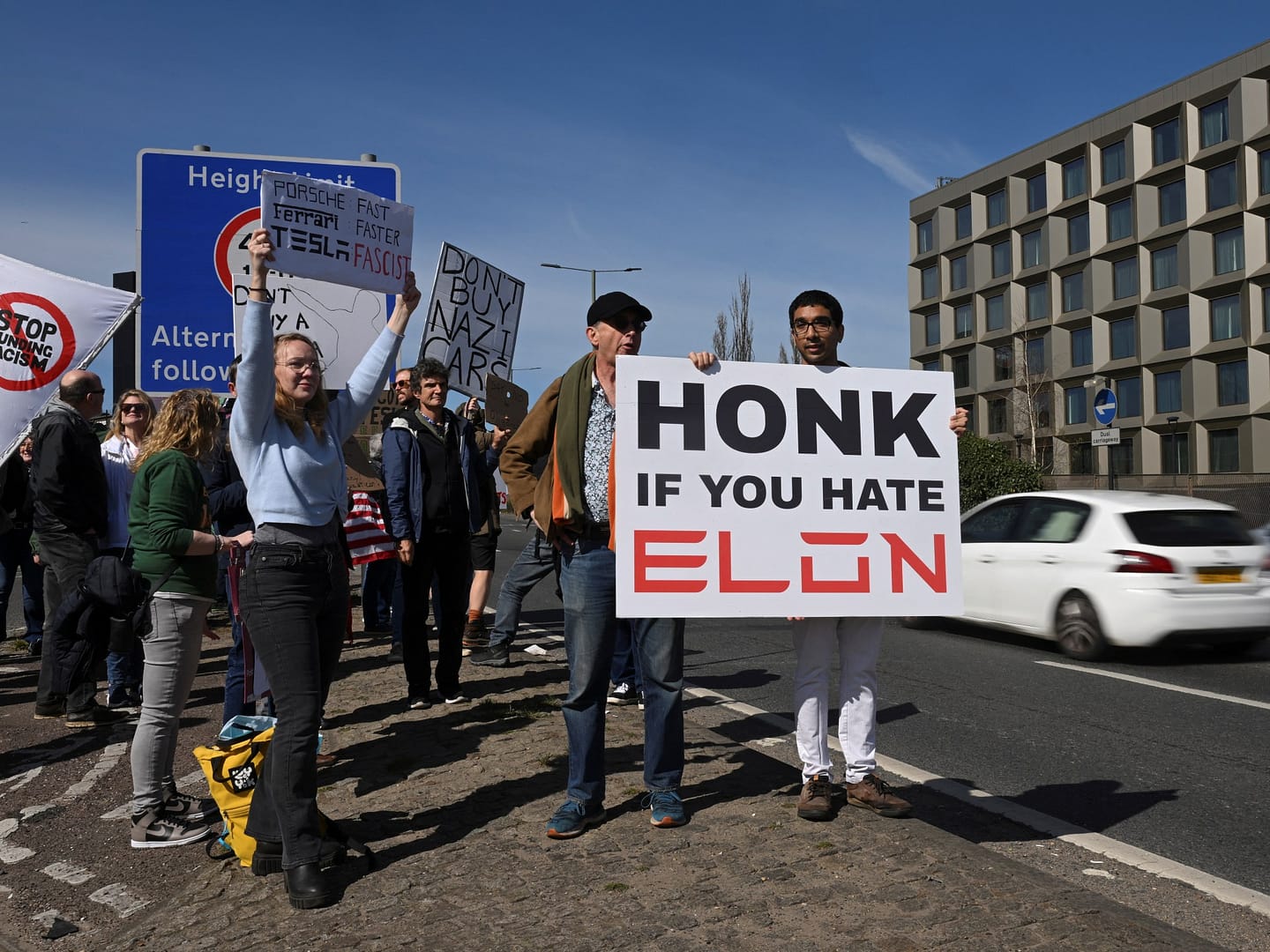 Elon Musk protesters gather at Tesla showrooms